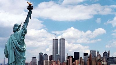 Manhattan, New York City skyline with World Trade Center and Statue of Liberty.