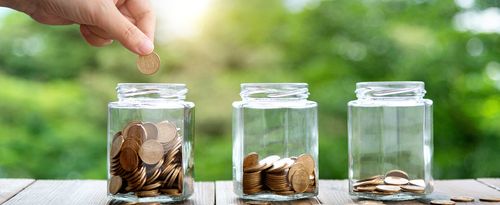 Three glass jars with coins.
